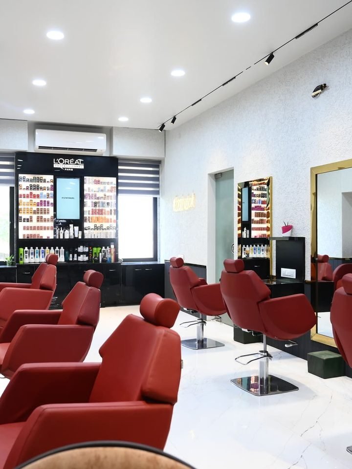 The styling floor at OK Salon, Tarabai Park, Kolhapur — chairs and product wall