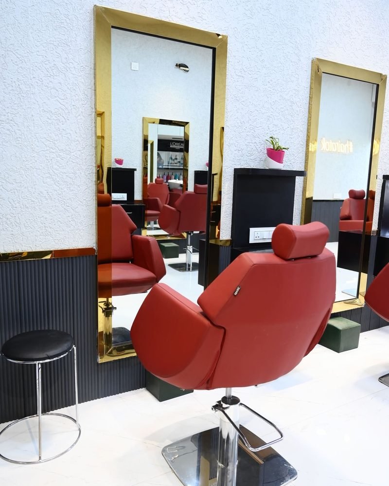 Styling chairs and gold-framed mirrors at OK Salon, Tarabai Park, Kolhapur